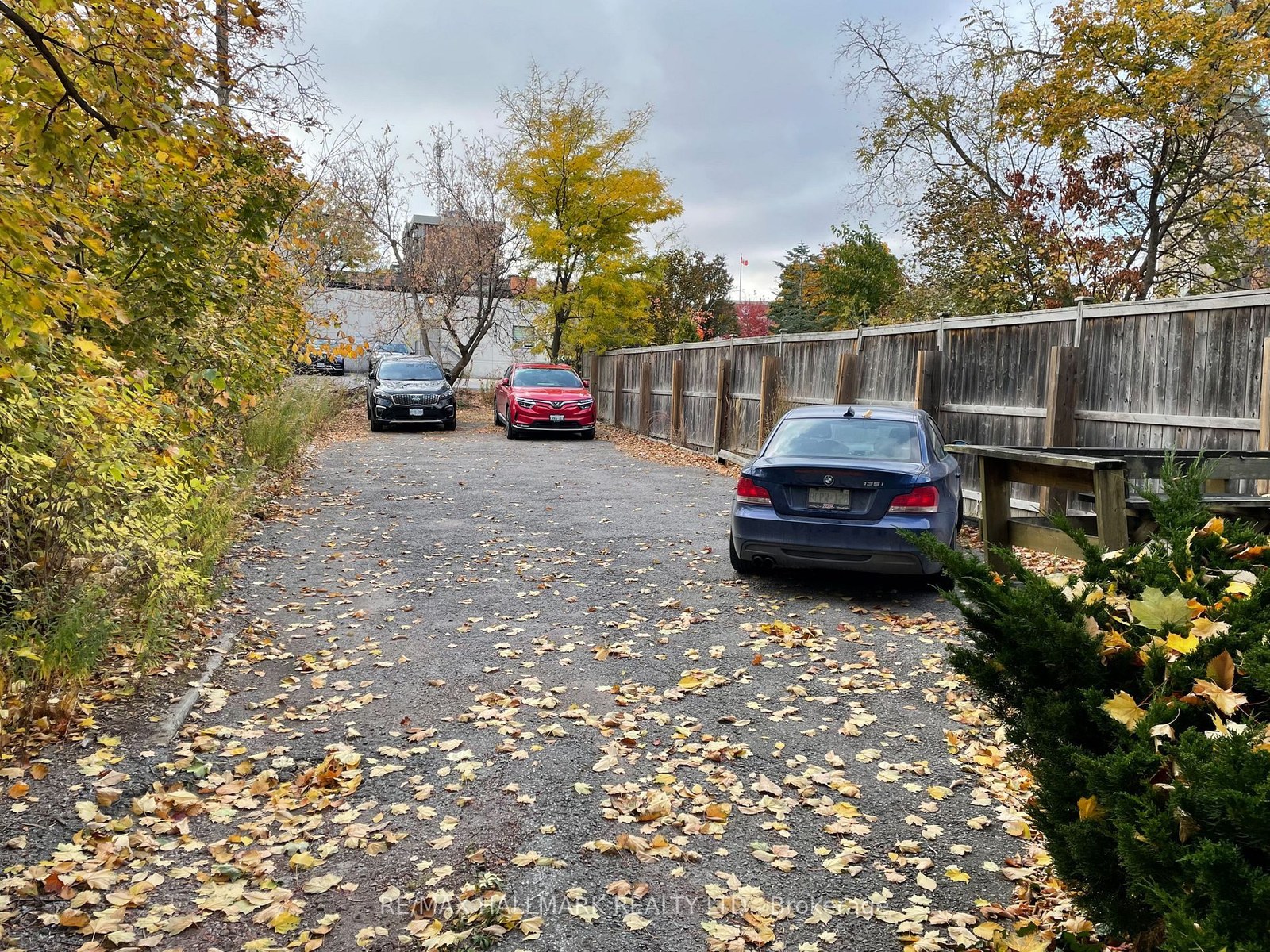 Rear parking lot with five paved spaces along the private driveway